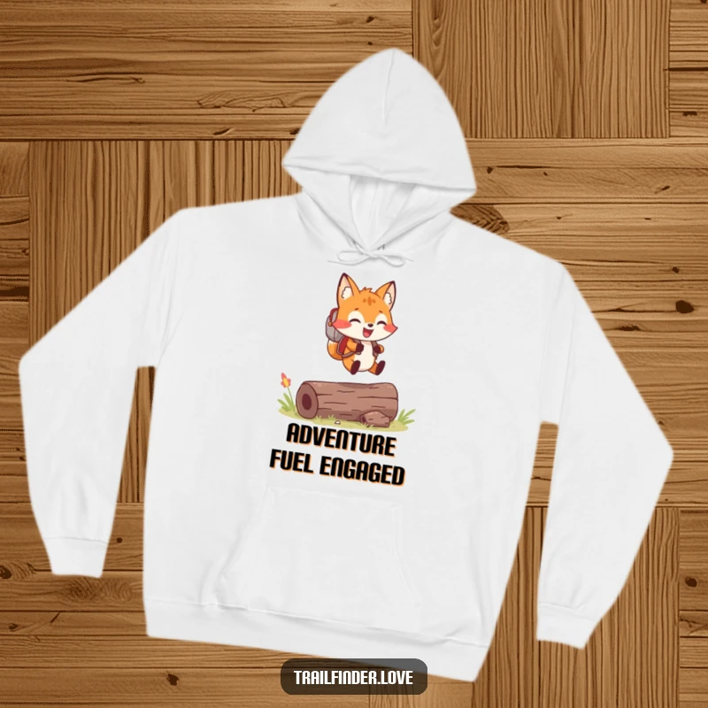 Funny hoodie with a cheerful fox wearing a tiny backpack, joyfully leaping over a log, ready for adventure.